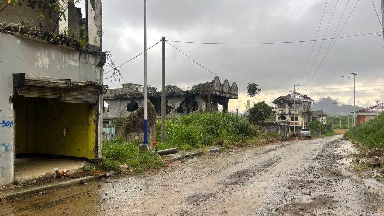 Derelict houses along and empty street in Marawi