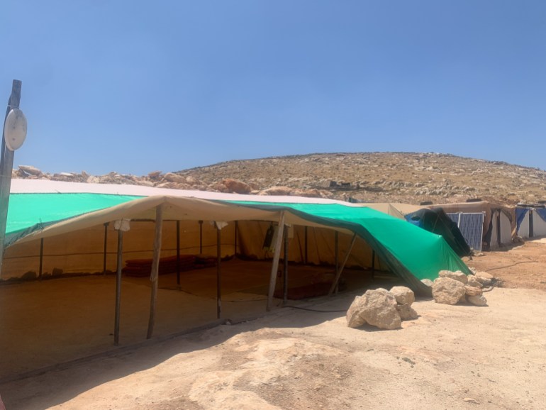 A look inside a temporary tent where four to five families sleep, open to the elements on one side