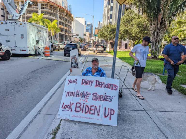Trump supporter Bob Kunst says he is sits outside the Miami courthouse holding a sign calling to lock Biden up