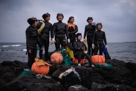 In a photo taken on November 6, 2015 a group of &#39;Haenyeo&#39; pose for photographers as they perform a demonstration during a media event organised by the Foreign Press Center, on South Korea&#39;s southern island of Jeju [Ed Jones/AFP]