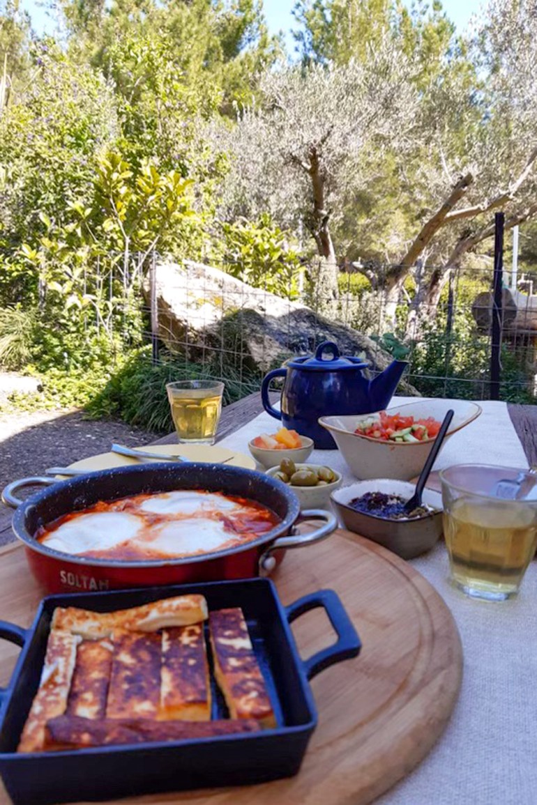 a view of the breakfast table with the garden in the background