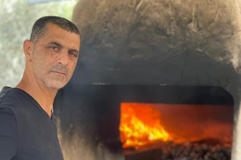 Akel Mamon standing in front of his taboon