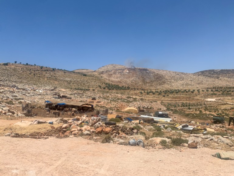 A view of the temporary refuge the families found, hills in the background