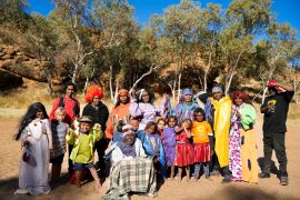 Aboriginal women and children in a group photo taken outside.