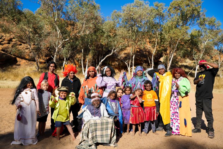Aboriginal women and children in a group photo taken outside.