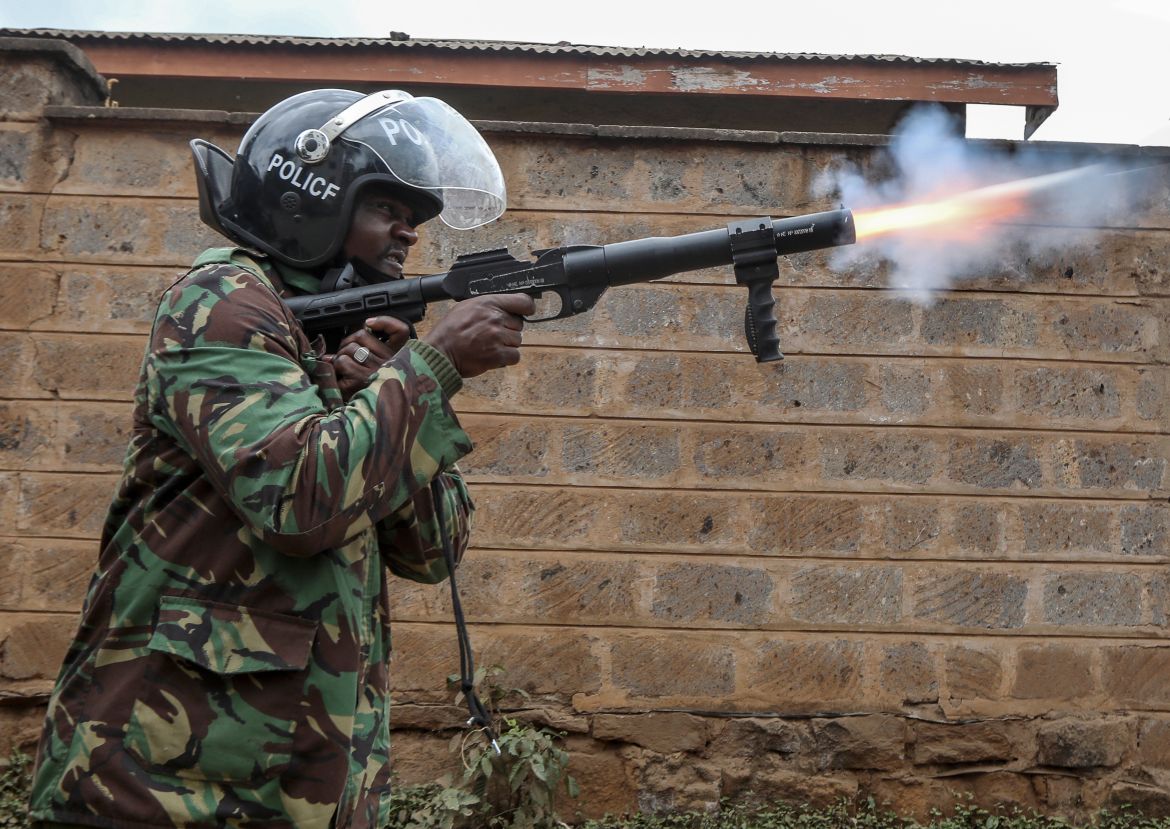 epa10755020 A riot police officer fires tear gas as they try to disperse demonstrators during a protest in Nairobi,