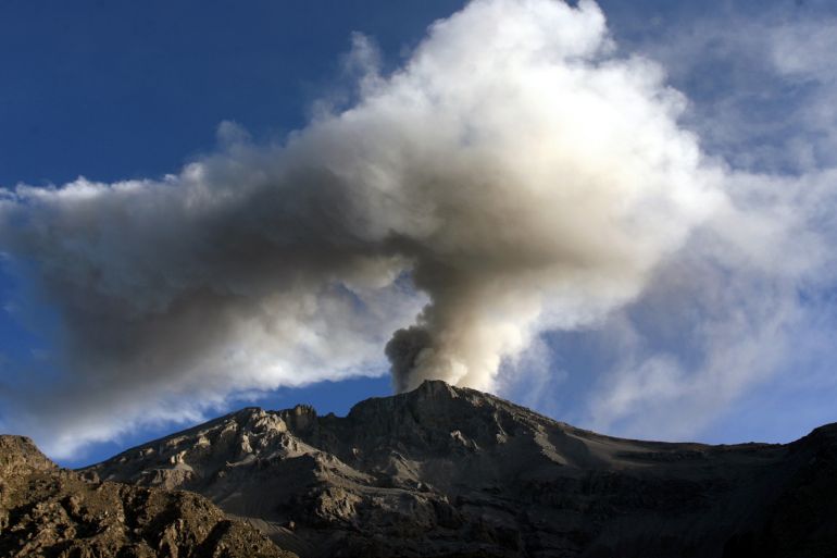 A volcano spews a tower of glass and ash.