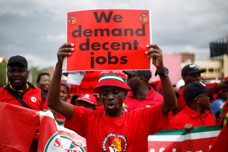 A man protests for better jobs in South Africa