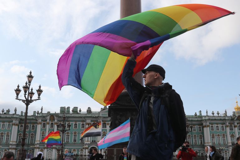 A participant waves a rainbow flag during the LGBT community rally "X St.Petersburg Pride" in central Saint Petersburg, Russia August 3, 2019. REUTERS/Anton Vaganov