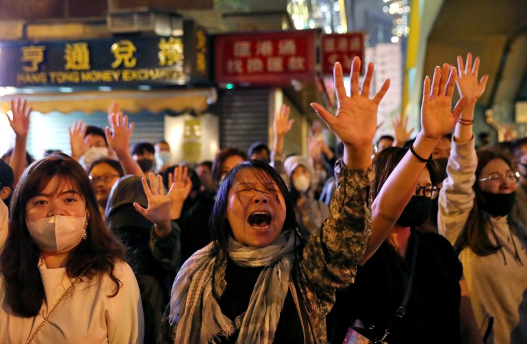 Protesters sing Glory to Hong Kong outside of Polytechnic University (PolyU) while police keep it under siege in Hong Kong, China