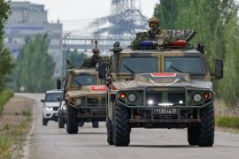 Russian military vehicles escort a motorcade with members of the International Atomic Energy Agency (IAEA) expert mission, who leave the Zaporizhzhia Nuclear Power Plant in the course of Russia-Ukraine conflict outside Enerhodar in the Zaporizhzhia region, Russian-controlled Ukraine, June 15, 2023. REUTERS/Alexander Ermochenko