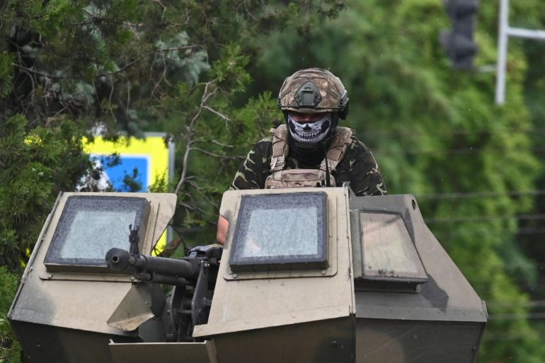 A fighter of Wagner private mercenary group is seen atop of an armoured vehicle in a street near the headquarters of the Southern Military District in the city of Rostov-on-Don, Russia, June 24, 2023. REUTERS/Stringer