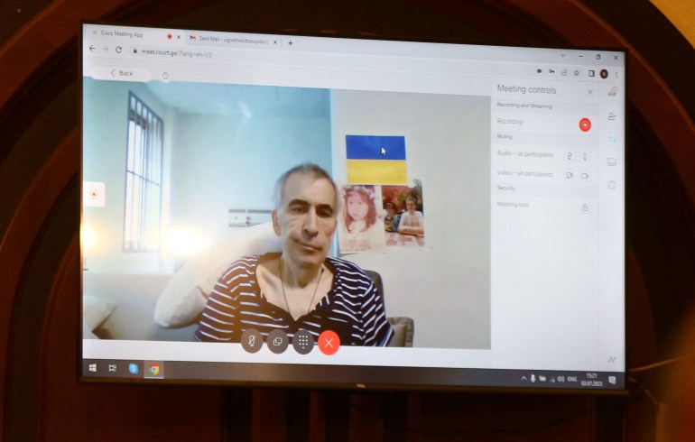 Georgia's imprisoned former President Mikheil Saakashvili appears on a screen via a video link from a clinic during a court hearing in the case of the violent crackdown on mass anti-government protests in 2007 in Tbilisi, Georgia, July 3, 2023.  REUTERS/Irakli Gedenidze