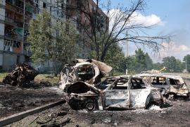 Burned cars are seen at a site of a Russian military strike in the town of Pervomaiskyi