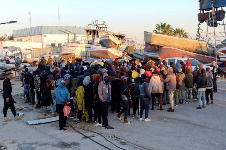 Migrants wait at Sfax port