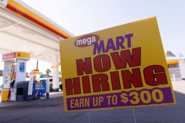 A job posting looking for workers is shown at a gas station in San Diego, California