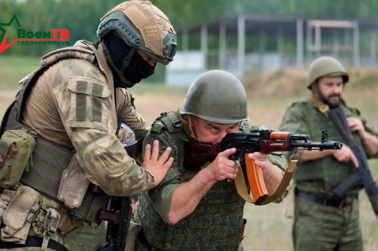 A fighter from Russian Wagner mercenary group conducts training for Belarusian soldiers