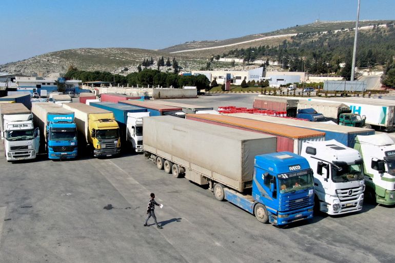 Trucks carrying aid from the UN World Food Programme (WFP), following a deadly earthquake, are parked at Bab al-Hawa crossing, Syria, February 20, 2023.