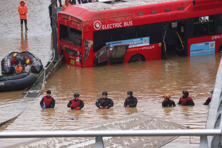 Rescue workers take part in a search and rescue operation near an underpass that has been submerged by a flooded river caused by torrential rain in Cheongju, South Korea, July 16, 2023.