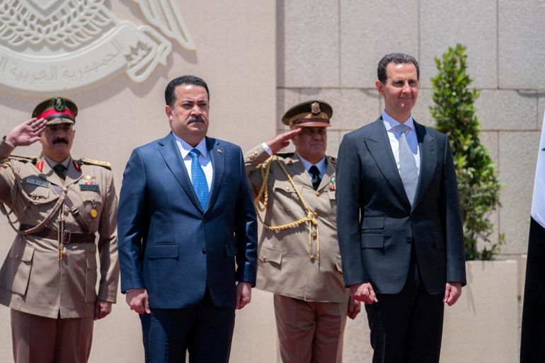 Syria's President Bashar al-Assad and Iraqi Prime Minister Mohammed Shia Al-Sudani view an honor guard in Damascus, Syria July 16, 2023. SANA/Handout via REUTERS ATTENTION EDITORS - THIS IMAGE WAS PROVIDED BY A THIRD PARTY. BEST QUALITY AVAILABLE