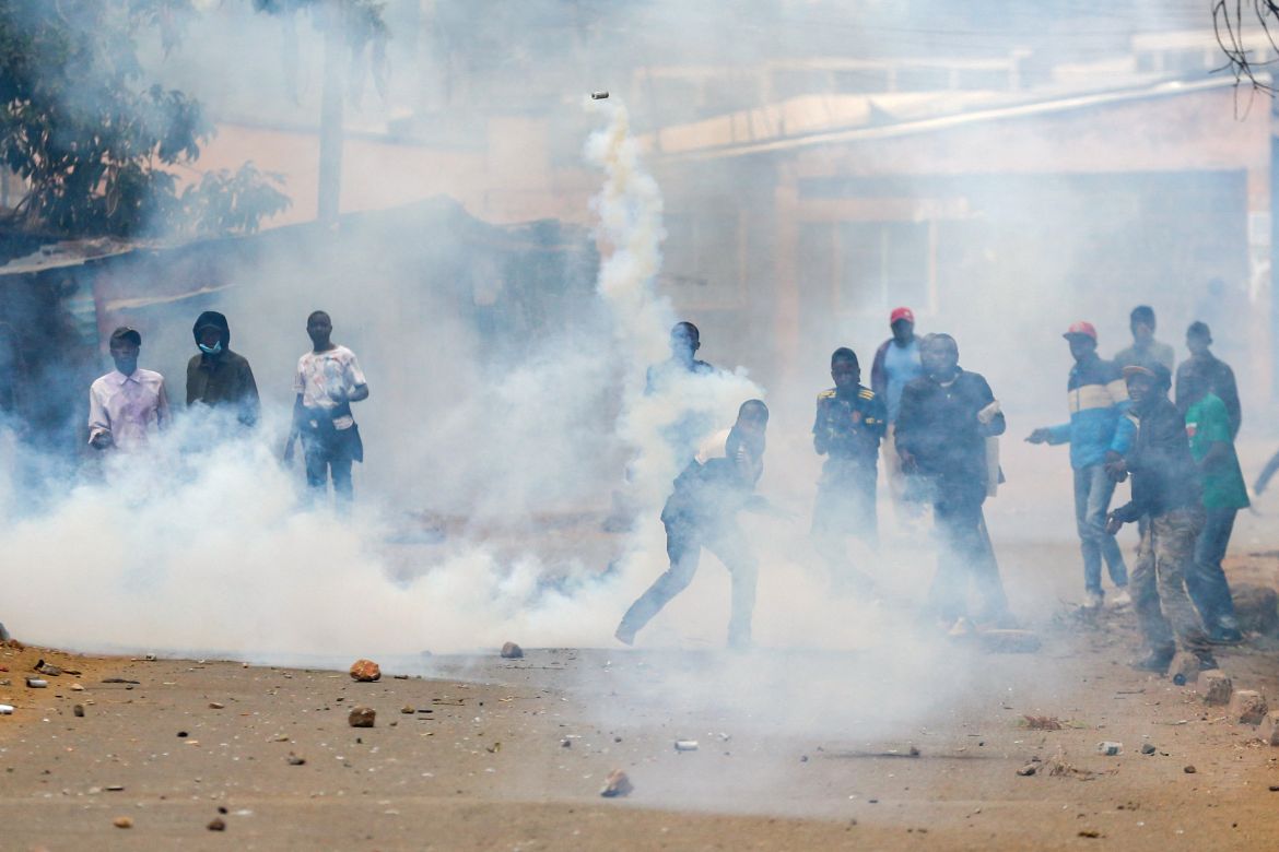 Supporters of Kenya's opposition leader Raila Odinga of the Azimio La Umoja (Declaration of Unity) One Kenya Alliance react to tear gas