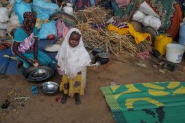 A Sudanese girl, who fled the conflict in Sudan's Darfur region with his family, stands at a temporary shelter in Adre, Chad.