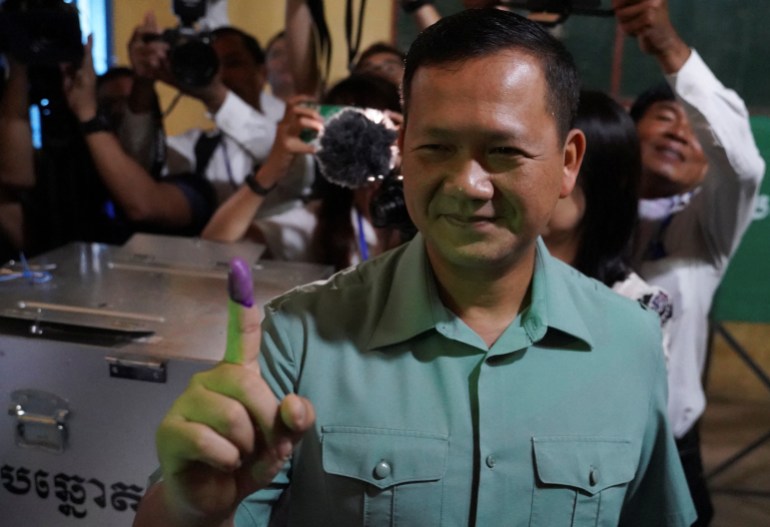 Hun Manet, son of Cambodia's Prime Minister Hun shows his inked finger after casting his vote during Cambodia's general election, in Phnom Penh, Cambodia, July 23, 2023. REUTERS/Cindy Liu