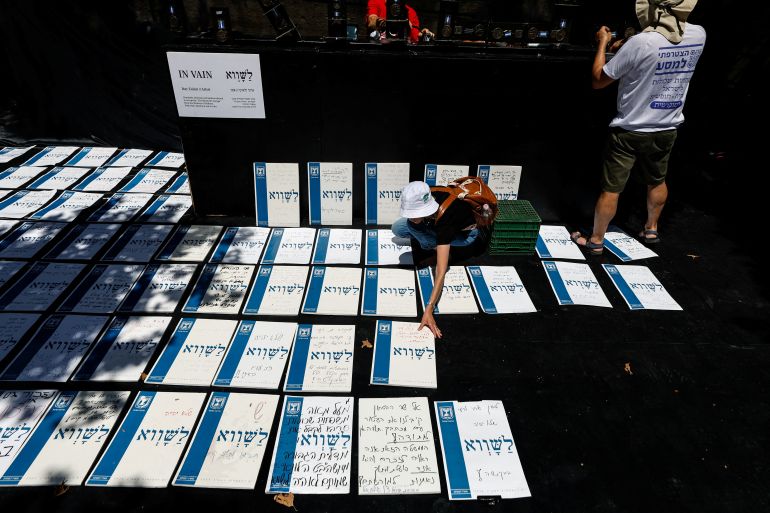 Protesters against the Israeli government's plans for judicial overhaul take part in an installation named "In Vain" at which family members of Israel's fallen soldiers write notes stating that their relatives fell in vain