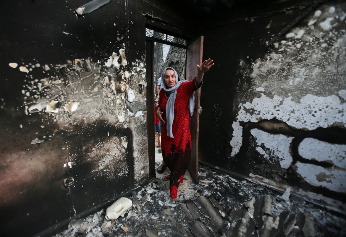 Souhila Belkati reacts inside her burnt house