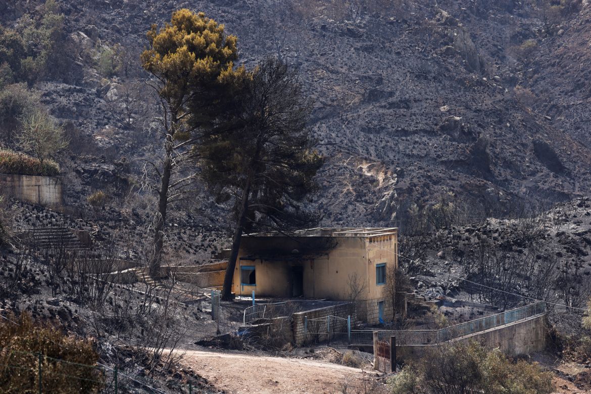 A burnt house is seen following a wildfire in the Sicilian village of Romitello