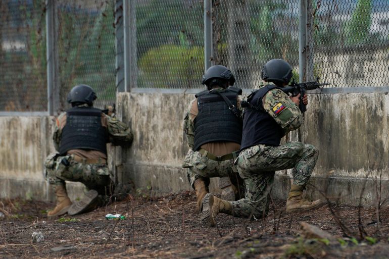 Soldiers guard a gate at a prison in Ecuador in 2022