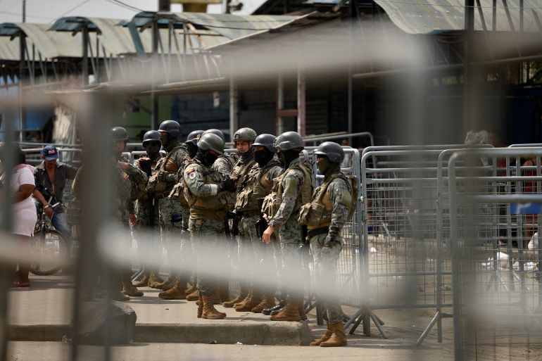 Ecuador security forces stand guard outside a prison