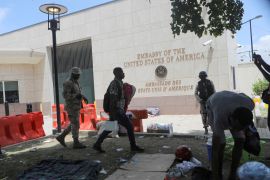 Haitian police clear a camp of displaced Haitians outside the US embassy in Port-au-Prince