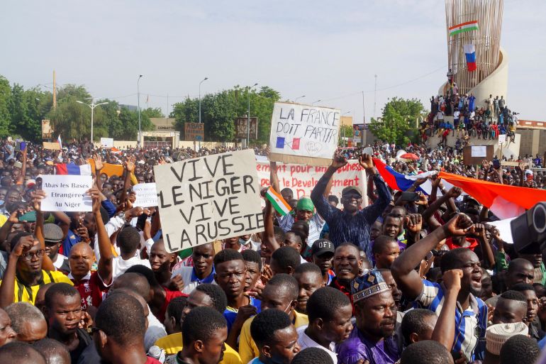 Demonstrators gather in support of the putschist soldiers in the capita Niamey, Niger July 30, 2023. Signs read "long live Niger, long live Russia", "France must leave".