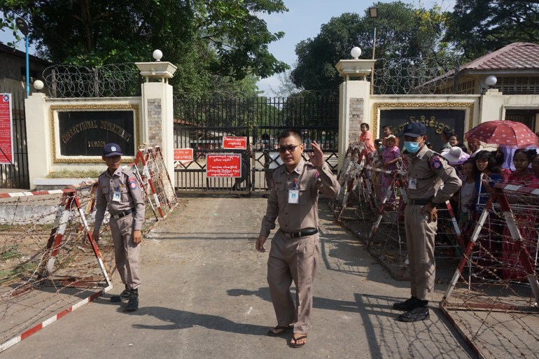 Prison officials outside the gates of Insein prison. 
