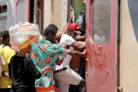 African migrants board a train