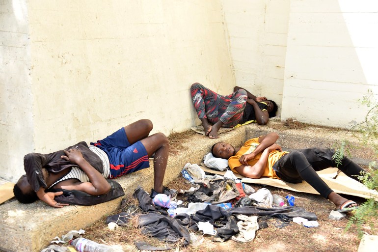 Migrants rest in a pubic space in Sfax