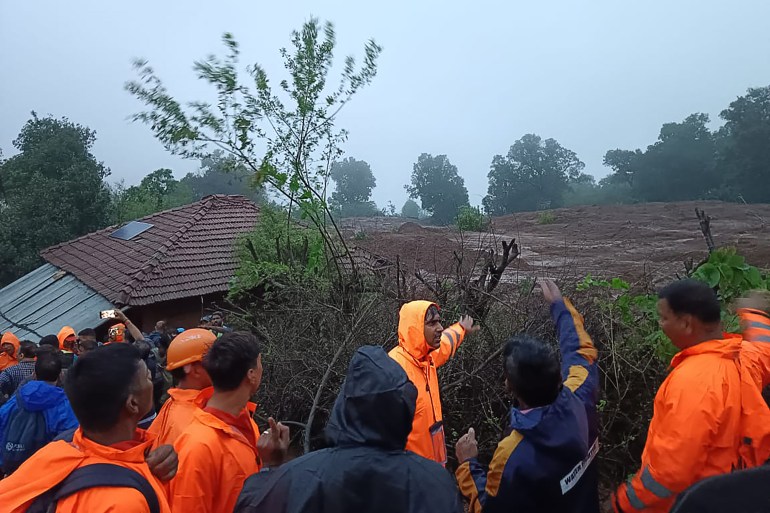 In this handout photograph released by Indias National Disaster Response Force (NDRF) and taken on July 20, 2023, NDRF personnel inspect the site of a landslide at Irshalwadi village of Raigad district in Maharashtra state. (Photo by - / Indias National Disaster Response Force (NDRF) / AFP) / RESTRICTED TO EDITORIAL USE - MANDATORY CREDIT  AFP PHOTO / INDIAS NATIONAL DISASTER RESPONSE FORCE (NDRF) - NO MARKETING - NO ADVERTISING CAMPAIGNS - DISTRIBUTED AS A SERVICE TO CLIENTS - RESTRICTED TO EDITORIAL USE - MANDATORY CREDIT  AFP PHOTO / Indias National Disaster Response Force (NDRF) - NO MARKETING - NO ADVERTISING CAMPAIGNS - DISTRIBUTED AS A SERVICE TO CLIENTS /