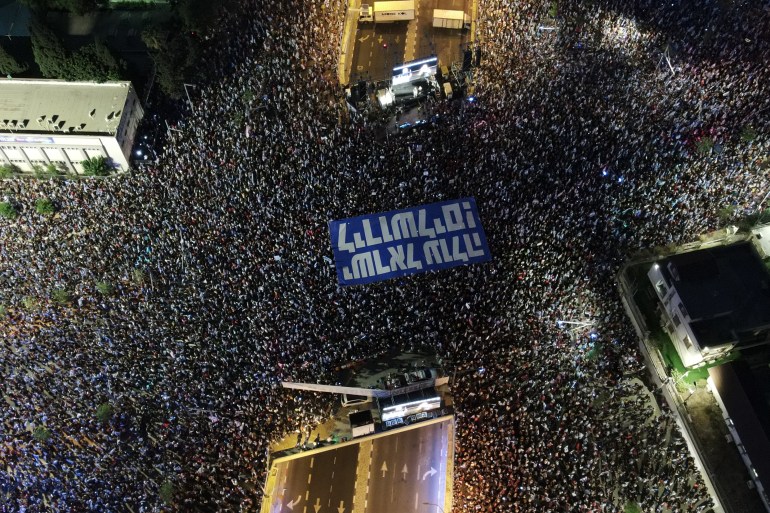 An aerial view shows demonstrators participating in a march in Tel Aviv on July 22, 2023.