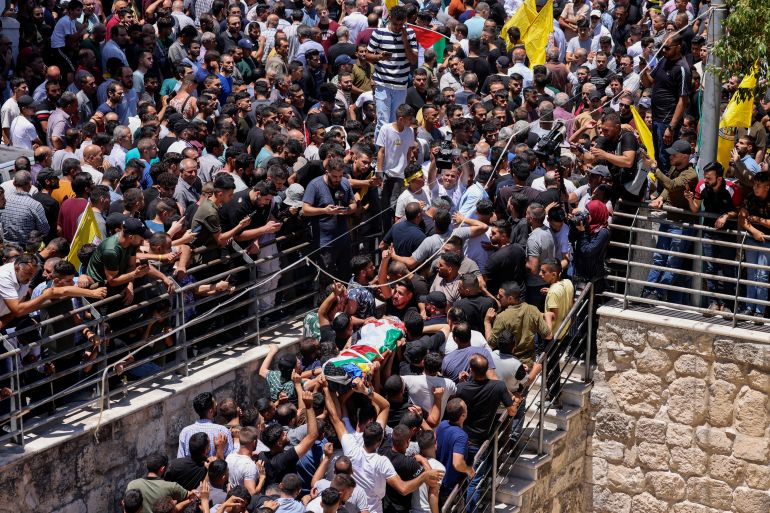 Palestinians carry the body of Fawzi Makhalfeh, 18, during his funeral in the town of Sebastia