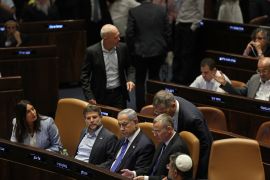 Israel's Prime Minister Benjamin Netanyahu (C) attends a parliament session in Jerusalem