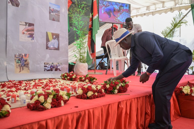 Kenyan opposition leader Raila Odinga lays flowers during the candle light vigil in memory of slain protesters from recent anti-government protests 