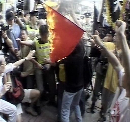 Protesters in Hong Kong in 2003 burn a Chinese flag