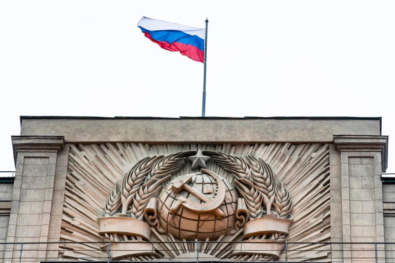 A Russian state flag waves on top of a hummer and sickle at the State Duma, lower parliament chamber, headquarters in Moscow, Russia, Tuesday, Feb. 14, 2017. Russian lawmakers are mounting a fierce defense of President Donald Trump's national security adviser who has resigned, following reports that he has misled White House officials about his contacts with Russia. (AP Photo/Alexander Zemlianichenko)