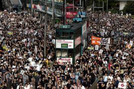 A mass protest in Hong Kong in 2003 over a planned security bill. There is a double decker bus in the middle of the crowd