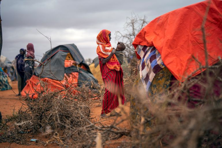 A Somali woman breastfeeds her child at a camp for displaced people on the outskirts of Dollow, Somalia on Sept. 20, 2022