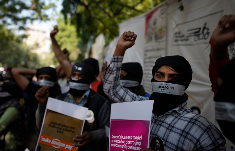 Gig Amazon Warehouse workers along with others shout slogans during a protest in New Delhi, India