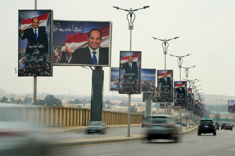 Cars drive past billboards that read Egyptian President Abdel Fattah al-Sisi in Arabic. "Our common goal is Egypt: our dream and hope" On a new highway in Cairo, Egypt, Wednesday, Feb. 22, 2023. Egypt is pushing for privatization to help its cash-strapped government, after pressure from the International Monetary Fund.  The new policy would be a serious departure for the Egyptian state, which has long maintained a tight grip on sectors of the economy.  (AP Photo/Amr Nabil)