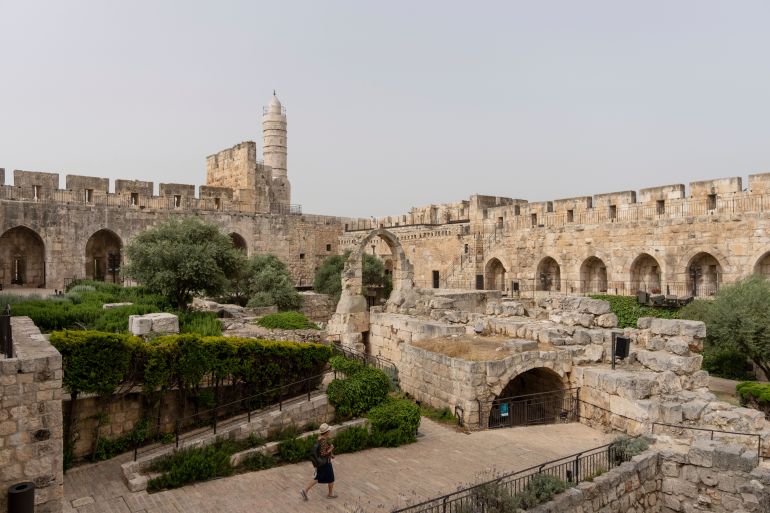 A woman walks at the inner courtyard of the Tower of David Museum, in Jerusalem's Old City, after a three-year renovation project, Monday, May 22, 2023. The tower, an ancient fortress on the western edge of the Old City, contains remnants of successive fortifications built one atop the other dating back over two millennia. (AP Photo/Ohad Zwigenberg)