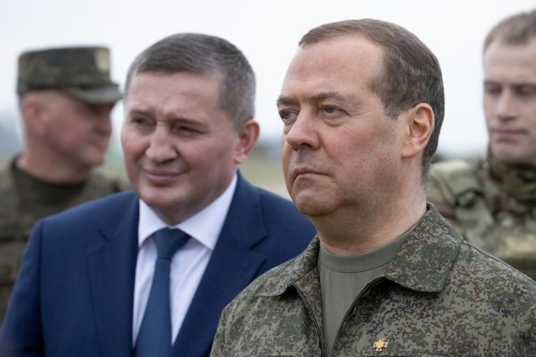 Russian Security Council Deputy Chairman and the head of the United Russia party Dmitry Medvedev, right, accompanied by Volgograd Region Governor Andrei Bocharov, left, visits the Prudboy military training ground in Volgograd region, Russia, Thursday, June 1, 2023. (Ekaterina Shtukina/Pool Photo via AP)